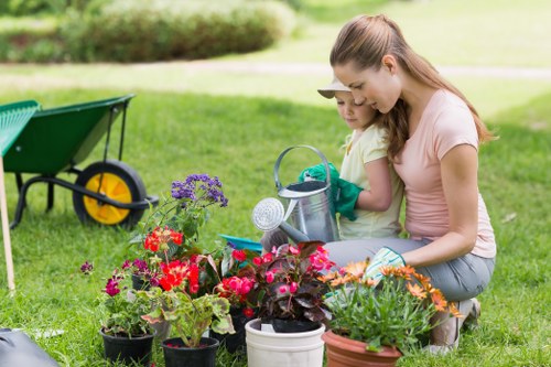 Gardener pruning shrubs in Ealing garden