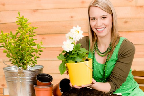 Gardener providing a written free quote at a suburban garden
