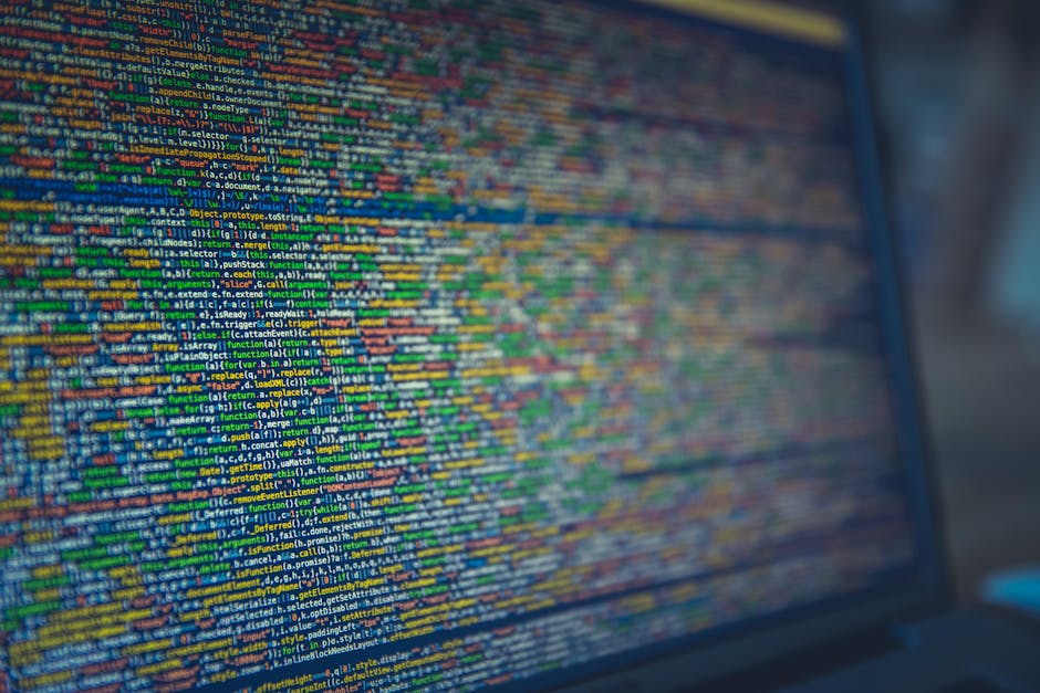 A computer screen displaying a dense and colorful array of programming code in various colors such as blue, yellow, green, and orange. The text consists of lines of code with numerous syntax elements,